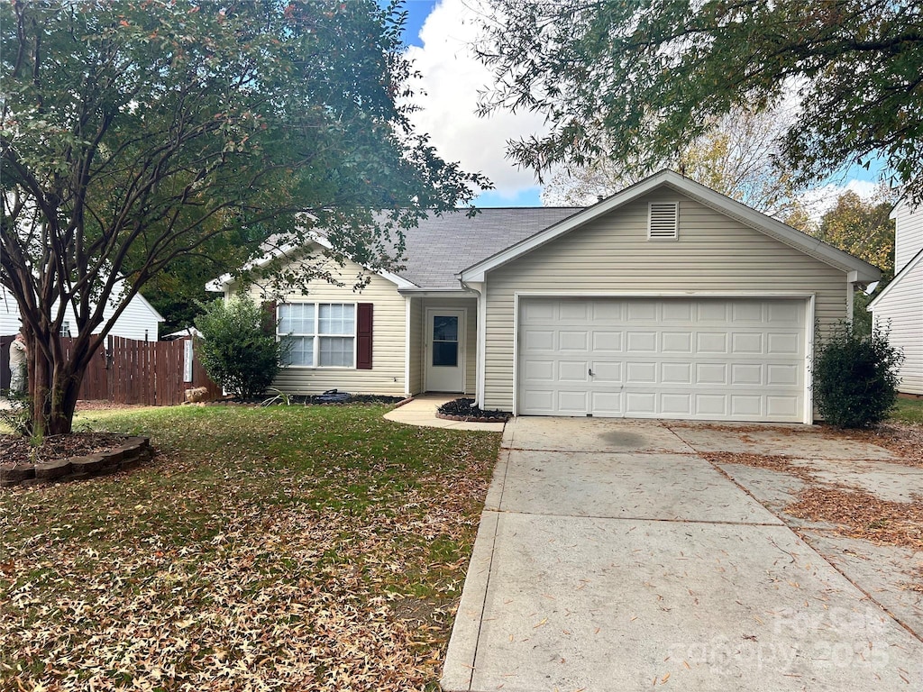 single story home with a front yard and a garage