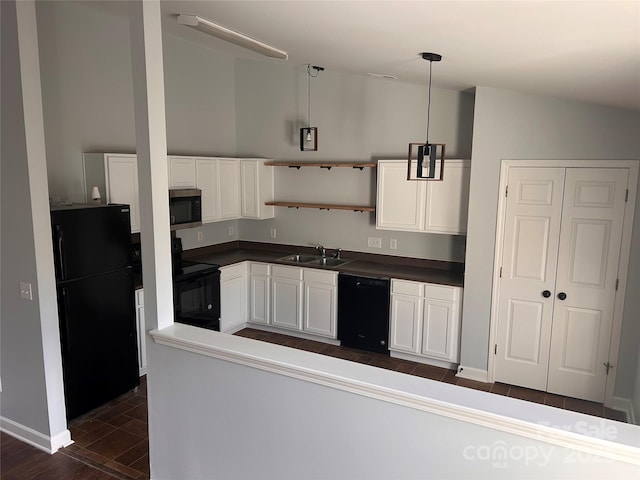 kitchen with black appliances, white cabinetry, sink, hanging light fixtures, and vaulted ceiling