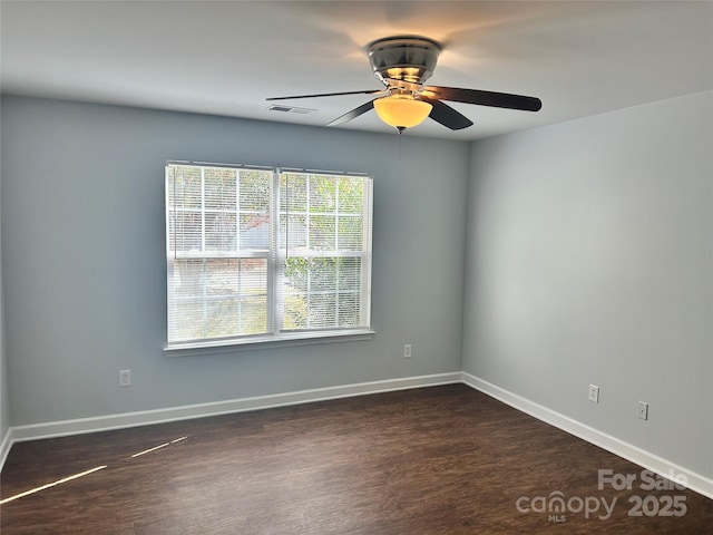 unfurnished room featuring ceiling fan and dark hardwood / wood-style flooring