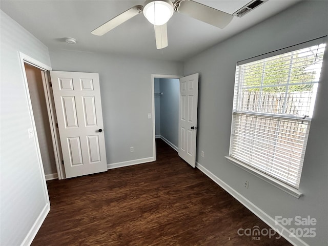 unfurnished bedroom featuring ceiling fan and dark hardwood / wood-style floors