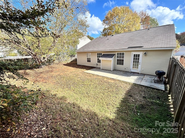 rear view of house with a patio area and a lawn