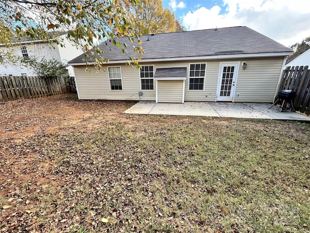 back of house featuring a yard and a patio