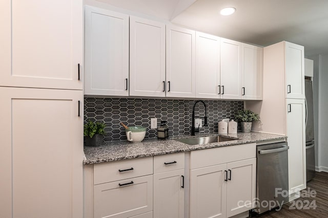 kitchen featuring dishwasher, sink, dark hardwood / wood-style flooring, white cabinets, and tasteful backsplash