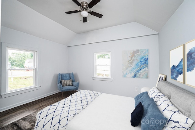 bedroom featuring dark hardwood / wood-style flooring, lofted ceiling, multiple windows, and ceiling fan