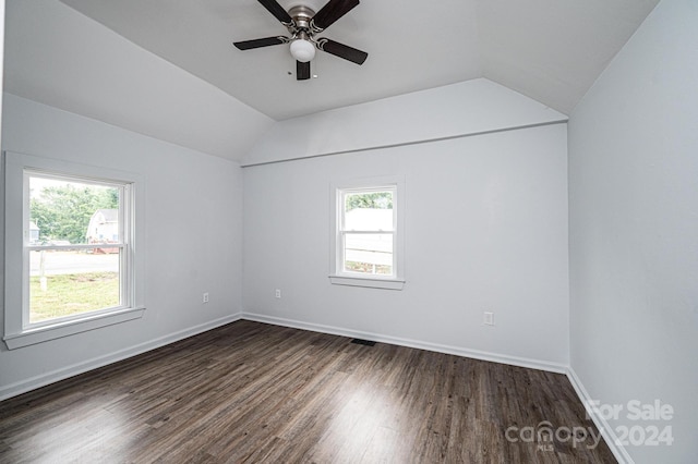 unfurnished room with a healthy amount of sunlight, lofted ceiling, and dark hardwood / wood-style flooring