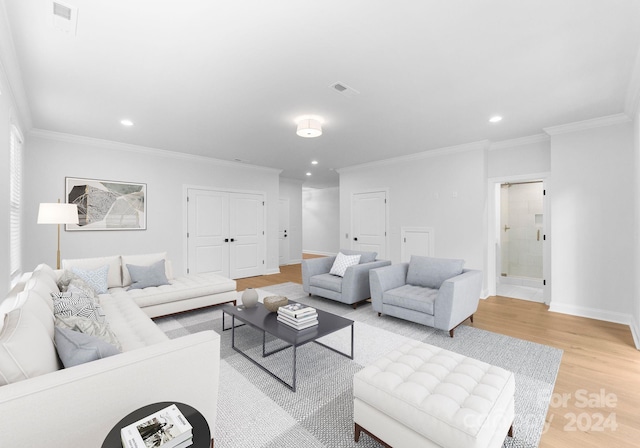 living room with crown molding and light wood-type flooring