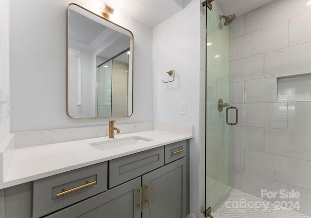 bathroom with vanity, ornamental molding, and walk in shower