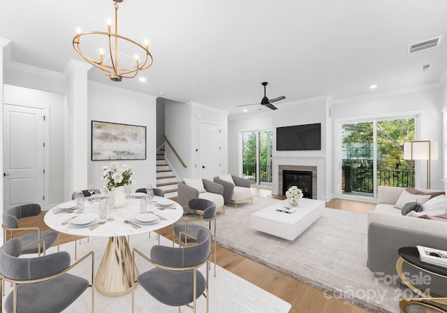 dining room with ornamental molding, light wood-type flooring, and plenty of natural light