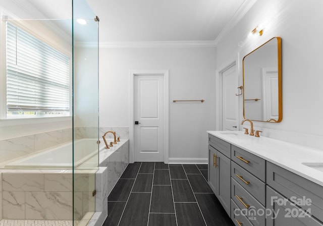 bathroom with vanity, a relaxing tiled tub, and ornamental molding