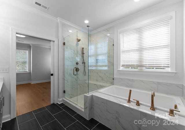 bathroom with separate shower and tub, crown molding, wood-type flooring, and a healthy amount of sunlight