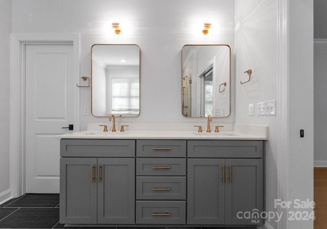 bathroom with vanity, crown molding, and wood-type flooring