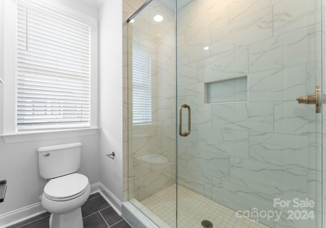 bathroom with toilet, walk in shower, and tile patterned floors