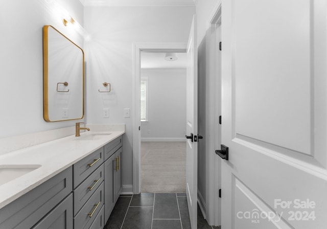 bathroom featuring vanity, crown molding, and tile patterned flooring