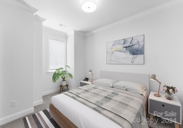 bedroom with crown molding and carpet