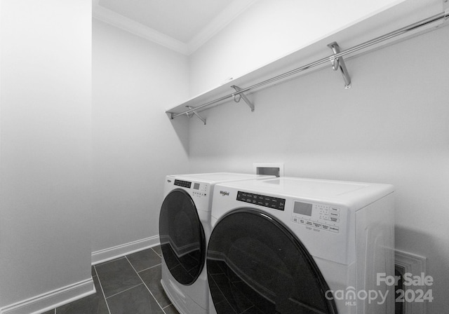 laundry area featuring dark tile patterned floors, ornamental molding, and washer and dryer