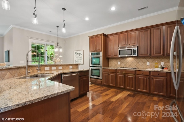 kitchen with ornamental molding, dark hardwood / wood-style floors, stainless steel appliances, and sink