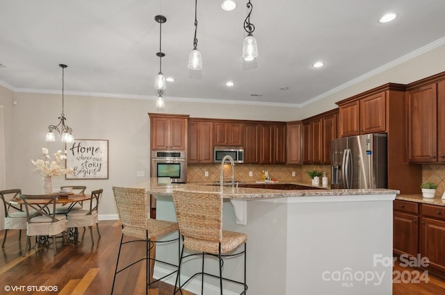 kitchen with dark wood-type flooring, a spacious island, stainless steel appliances, and decorative light fixtures