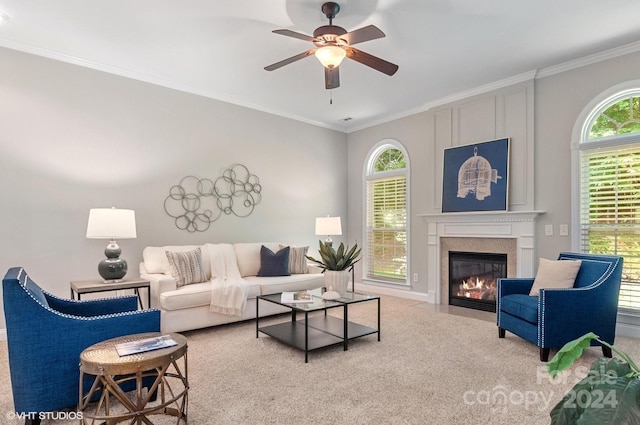 carpeted living room featuring crown molding, plenty of natural light, and ceiling fan