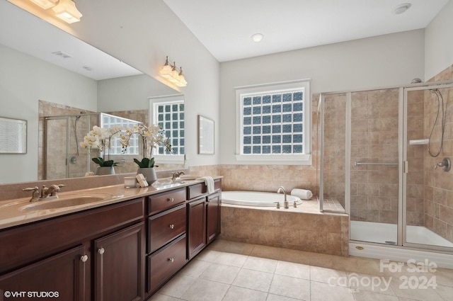 bathroom featuring vanity, shower with separate bathtub, and a wealth of natural light