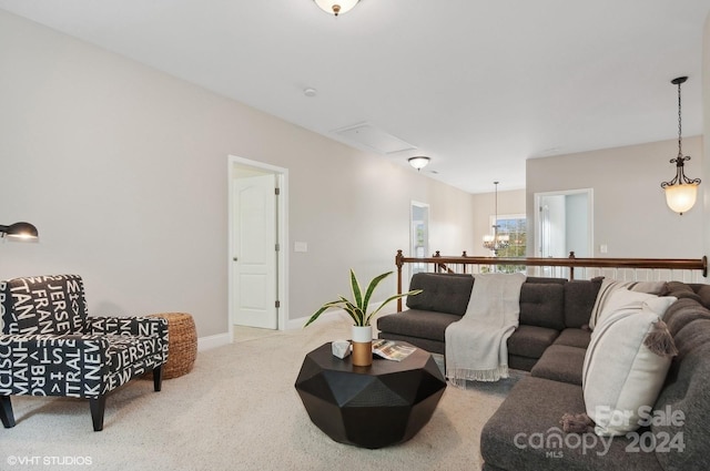 carpeted living room with a notable chandelier