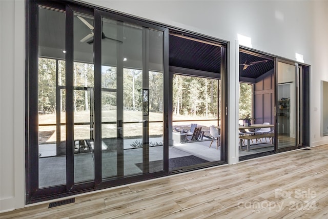 entryway featuring vaulted ceiling, hardwood / wood-style flooring, and plenty of natural light