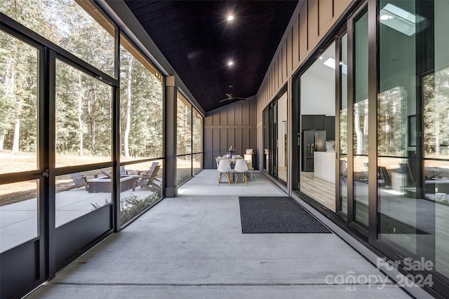 unfurnished sunroom with lofted ceiling and plenty of natural light