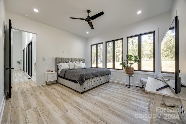 bedroom with light hardwood / wood-style flooring and ceiling fan