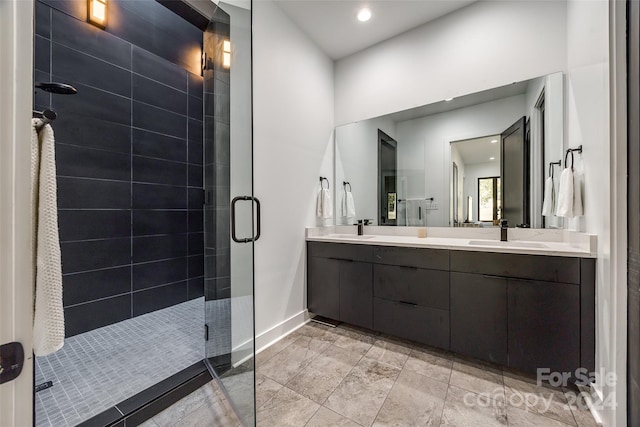 bathroom with vanity and a shower with shower door