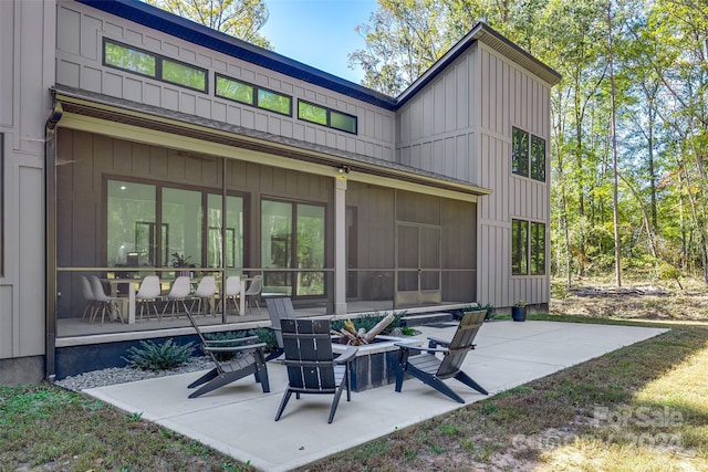 rear view of house with a patio and a sunroom