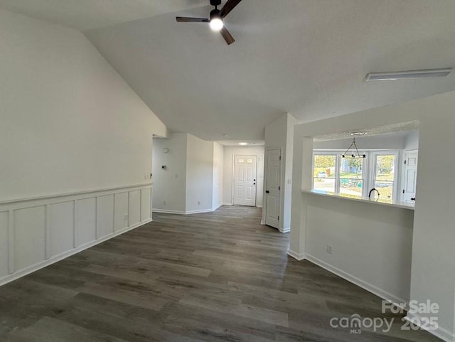 empty room with dark wood-type flooring, lofted ceiling, and ceiling fan