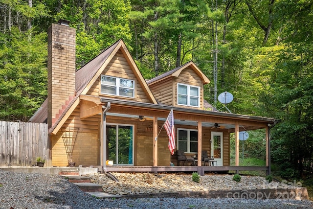 back of house featuring covered porch and ceiling fan