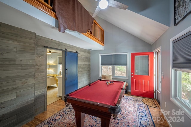 recreation room with light hardwood / wood-style floors, a barn door, pool table, and ceiling fan