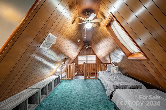 carpeted bedroom featuring ceiling fan, wood walls, and lofted ceiling with skylight