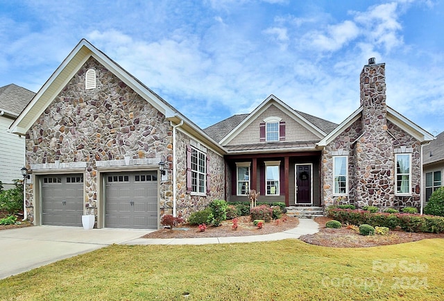 craftsman-style house featuring a front yard and a garage