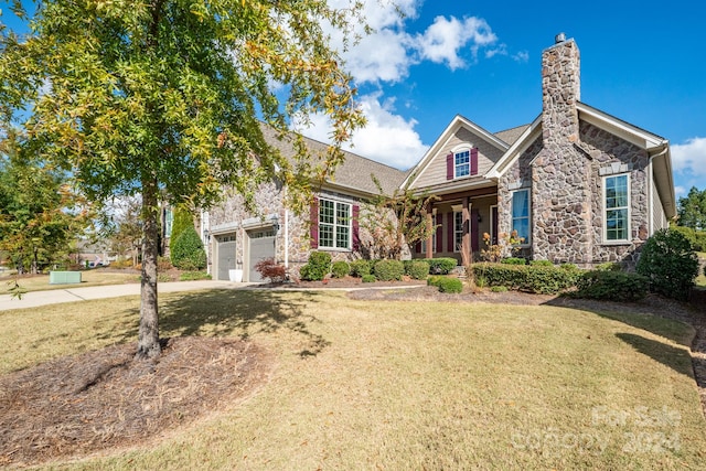 view of front of home featuring a front yard and a garage