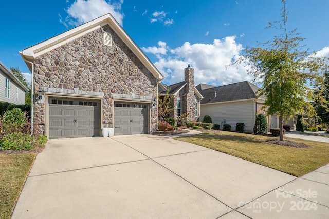 front of property with a front yard and a garage