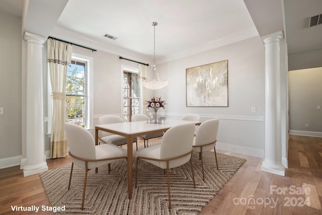 dining space featuring ornamental molding and hardwood / wood-style floors