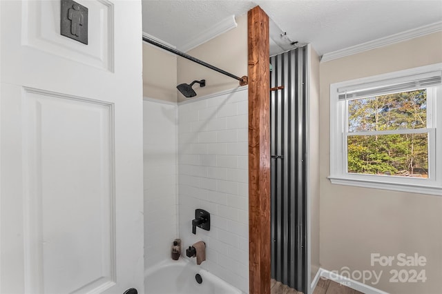 bathroom with crown molding, tiled shower / bath combo, a textured ceiling, and hardwood / wood-style floors