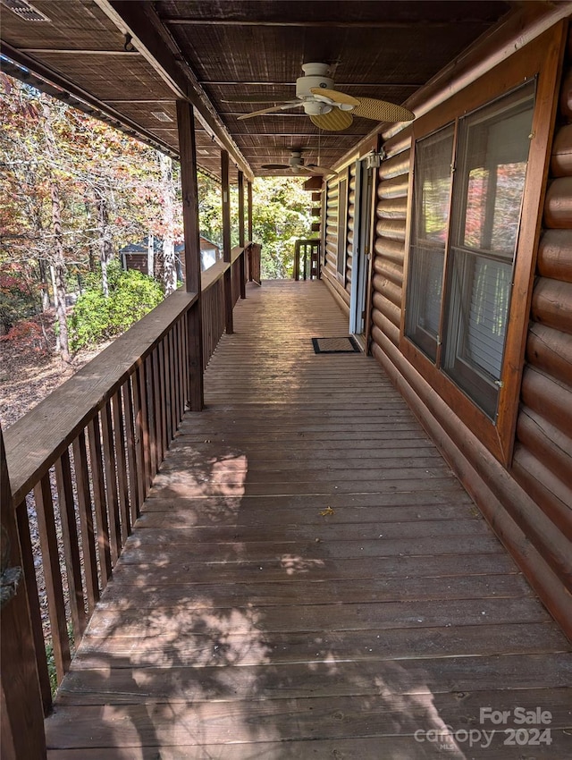 wooden terrace featuring ceiling fan