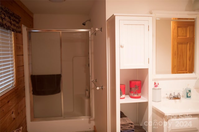 bathroom with wooden walls and an enclosed shower