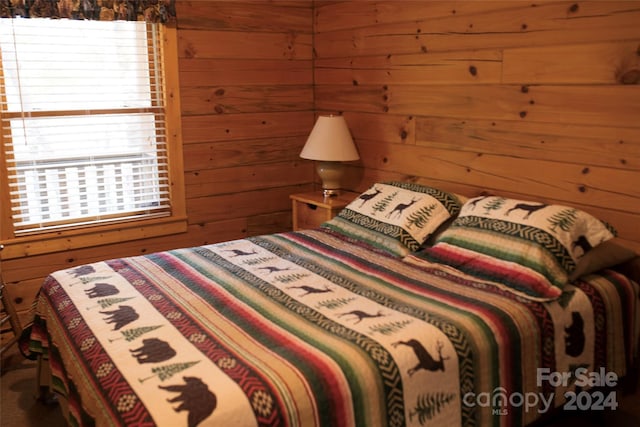 bedroom featuring wood walls