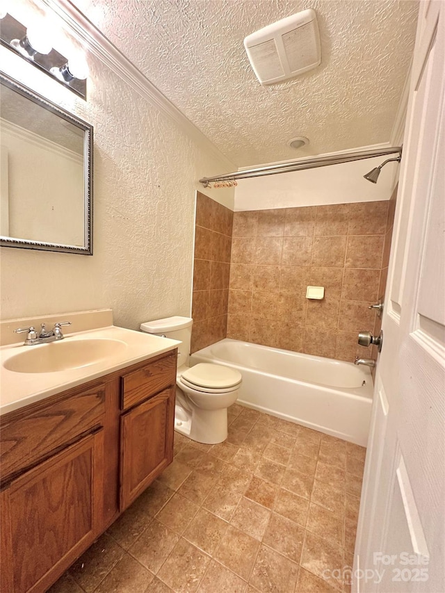 full bathroom with tiled shower / bath combo, vanity, a textured ceiling, and toilet