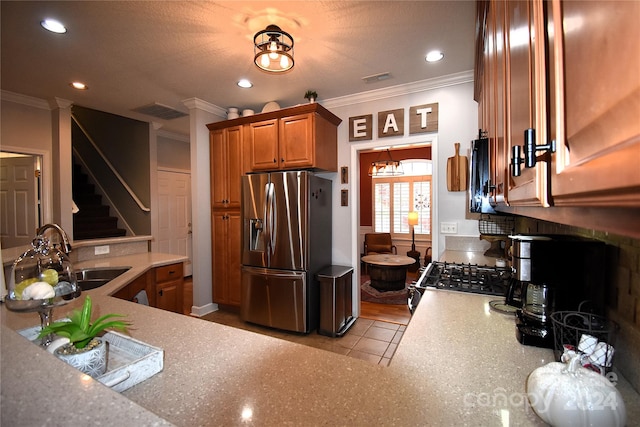 kitchen with ornamental molding, stainless steel appliances, sink, and light tile patterned floors