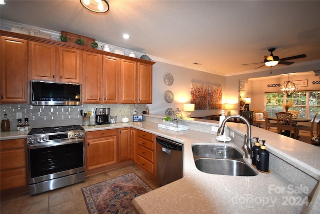 kitchen featuring backsplash, appliances with stainless steel finishes, sink, and ornamental molding