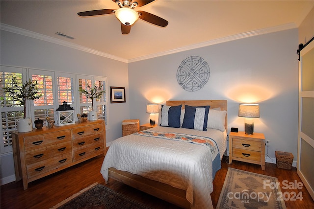 bedroom with dark wood-type flooring, ceiling fan, crown molding, and a barn door