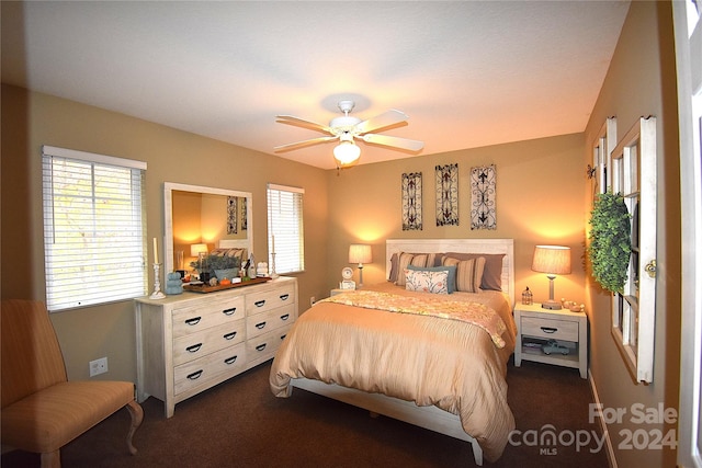 bedroom featuring dark carpet and ceiling fan