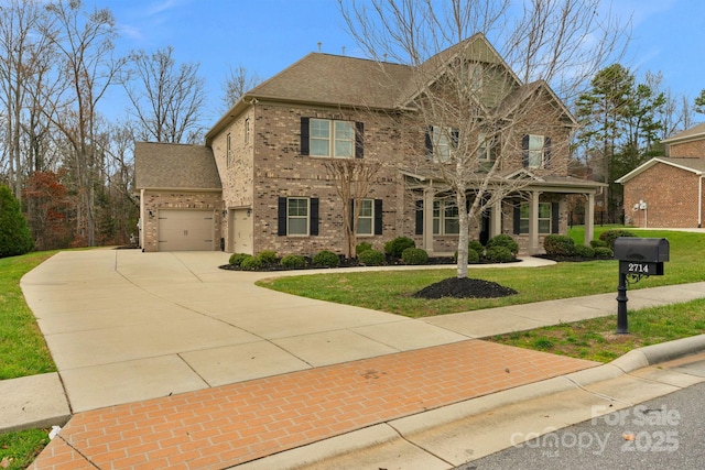 view of front of home featuring a front lawn and a garage