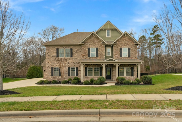 craftsman inspired home with a front lawn