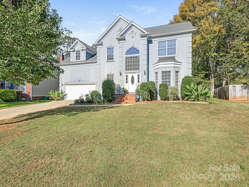 front facade featuring a front yard and a garage