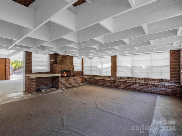 interior space featuring brick wall and a fireplace